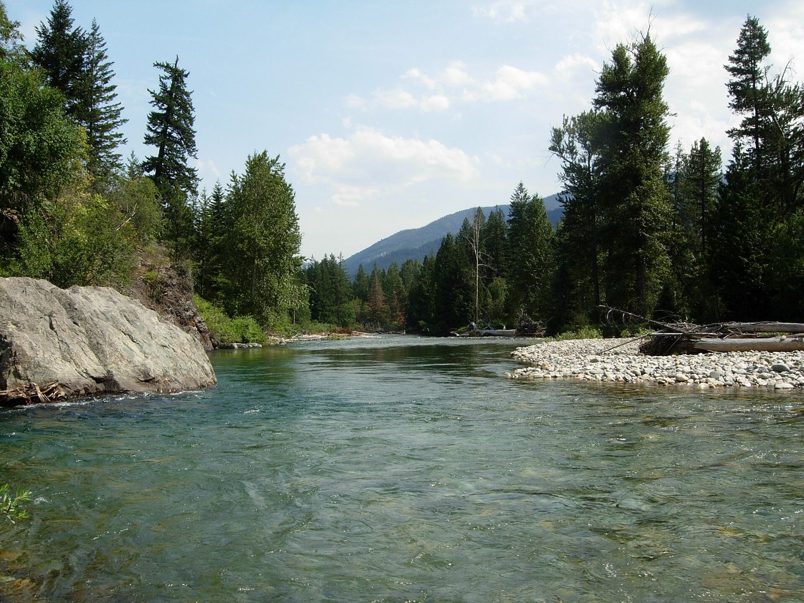 The Methow River flowing past pines and granite boulders